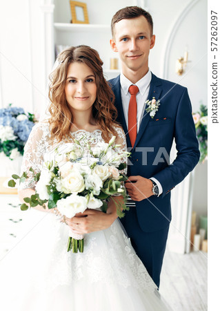 Beautiful bride in white dress and groom in suit, 57262097