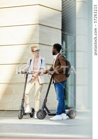 Young People Riding Electric Scooters in City Young People Riding Electric Scooters in City 57263215