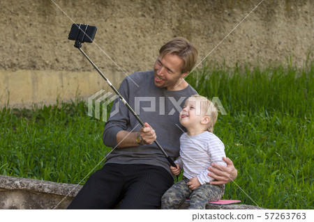 Father and son doing selfie Father and son doing selfie 57263763