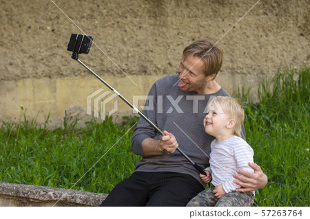Father and son doing selfie Father and son doing selfie 57263764