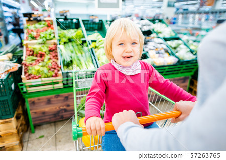 Mother and toddler with shopping cart in supermarket Mother and toddler with shopping cart in supermarket 57263765
