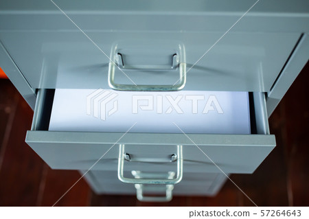 Filing cabinet with open drawer, White papers  for write letter, Silver metal colour, Administration and storage concept, closeup & Macro shot, Selective focus 57264643