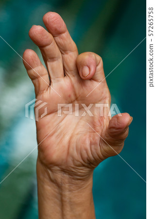 Trigger Finger lock on index finger of senior woman's right hand, Suffering from pain, Swimming pool background, Health care concept 57265758