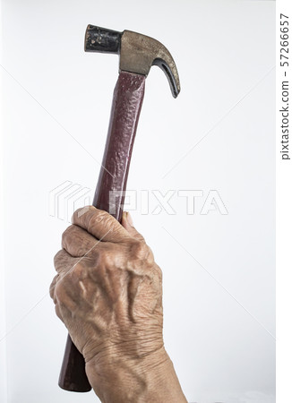 Senior Woman's left hand holding hammer on white background, Construction building and repair tool concept 57266657