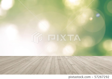 Wooden floor with blurred nature background yellow green tree leaves looking up against sky with sun flare Wooden floor with blurred nature background yellow green tree leaves looking up against sky with sun flare 57267292