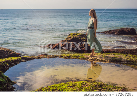 Young woman tourist on Pantai Tegal Wangi Beach, Bali Island, Indonesia. Bali Travel Concept Young woman tourist on Pantai Tegal Wangi Beach, Bali Island, Indonesia. Bali Travel Concept 57267293