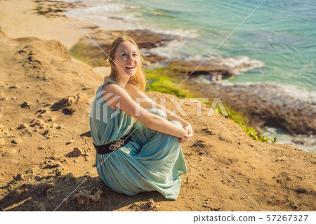 Young woman tourist on Pantai Tegal Wangi Beach, Bali Island, Indonesia. Bali Travel Concept Young woman tourist on Pantai Tegal Wangi Beach, Bali Island, Indonesia. Bali Travel Concept 57267327