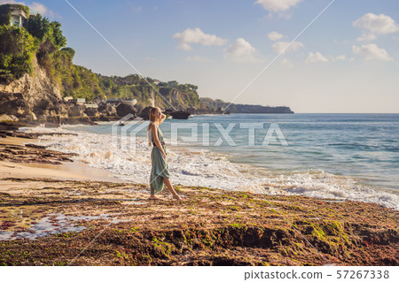 Young woman tourist on Pantai Tegal Wangi Beach, Bali Island, Indonesia. Bali Travel Concept 57267338