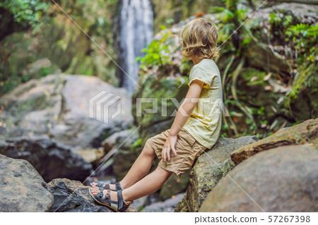 Children rest during a hike in the woods Children rest during a hike in the woods 57267398