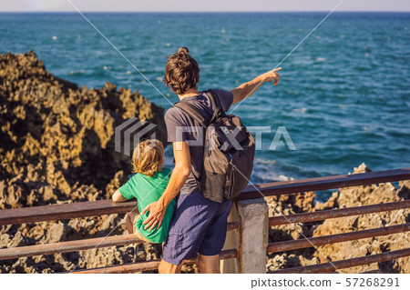 Father and son travelers on amazing Nusadua, Waterbloom Fountain, Bali Island Indonesia. Traveling 57268291