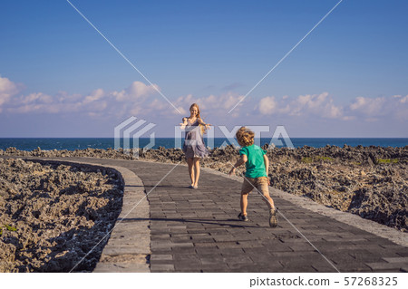 Mom and son travelers on amazing Nusadua, Waterbloom Fountain, Bali Island Indonesia. Traveling with 57268325