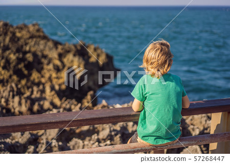Boy traveler on amazing Nusadua, Waterbloom Fountain, Bali Island Indonesia. Traveling with kids Boy traveler on amazing Nusadua, Waterbloom Fountain, Bali Island Indonesia. Traveling with kids 57268447