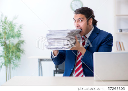 Young male businessman sitting in the office Young male businessman sitting in the office 57268803