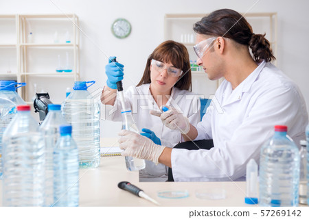 Two chemists working in the lab Two chemists working in the lab 57269142