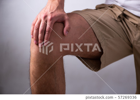 Young man suffering from leg pain 57269336