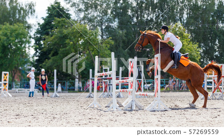 Horse rider woman on show jumping competition 57269559