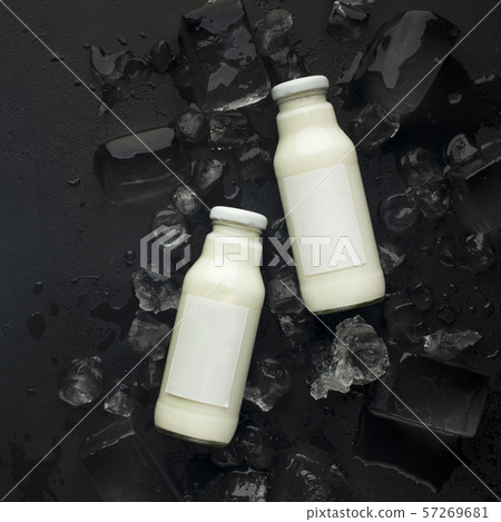 Vegetarian coconut or almond milk in bottles on black Vegetarian coconut or almond milk in bottles on black 57269681