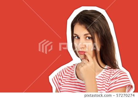 embarrassed young woman laughs look at the camera. 57270274