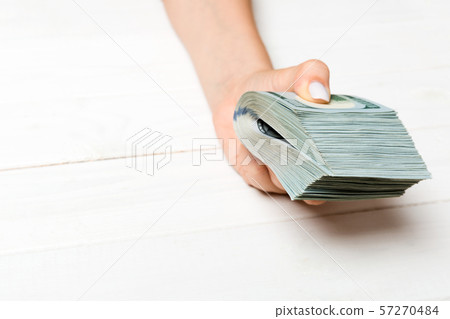 Perspective view of female hand holding a pack of Perspective view of female hand holding a pack of 57270484