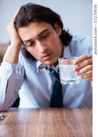 Sick male employee suffering in the office 57270656