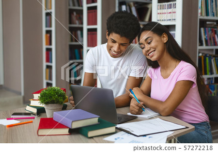 Couple of black students working on project in library 57272218