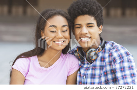 Teenage couple posing for selfie looking at camera on smartphone Teenage couple posing for selfie looking at camera on smartphone 57272221