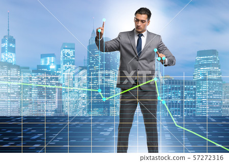 Businessman controlling the market with strings Businessman controlling the market with strings 57272316