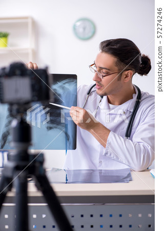 Young male doctor radiologist recording video for his blog 57274246