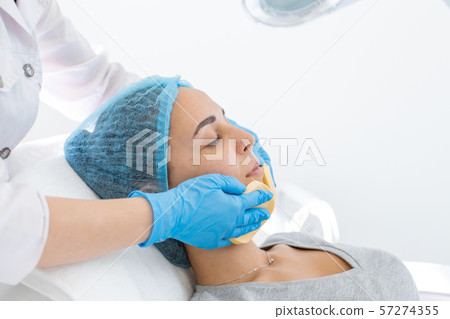beautician makes client facial massage yellow beautician makes client facial massage yellow 57274355