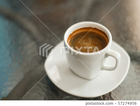 Coffee americano on the glass table, close up Coffee americano on the glass table, close up 57274956