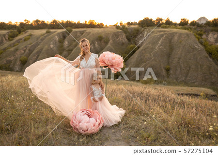 Mom with daughter in pink fairy-tale dresses walk Mom with daughter in pink fairy-tale dresses walk 57275104