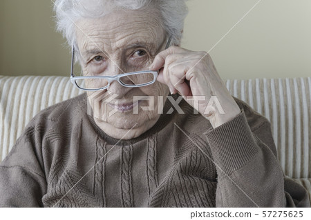 Senior woman wearing eyeglasses Senior woman wearing eyeglasses 57275625