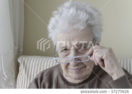 Senior woman wearing eyeglasses Senior woman wearing eyeglasses 57275626