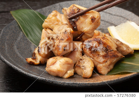 Charcoal grilling of chicken 57276380