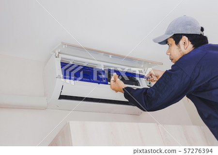 Air conditioning repairman in the blue uniform Air conditioning repairman in the blue uniform 57276394