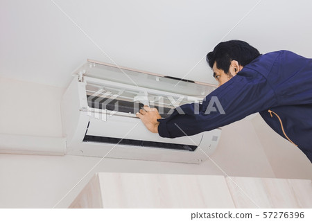 Air conditioning repairman in the blue uniform Air conditioning repairman in the blue uniform 57276396