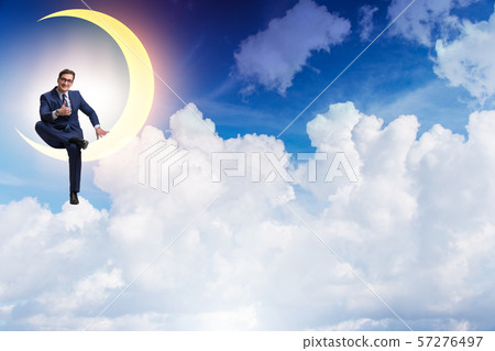 Businessman sitting on the crescent moon Businessman sitting on the crescent moon 57276497