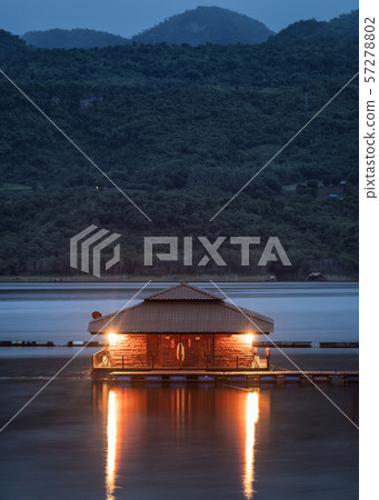 Wooden raft resort shining with hill on lake in Wooden raft resort shining with hill on lake in 57278802