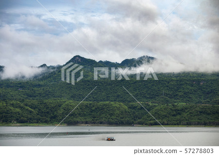 Scenery of mountain with foggy and boat sailing on Scenery of mountain with foggy and boat sailing on 57278803