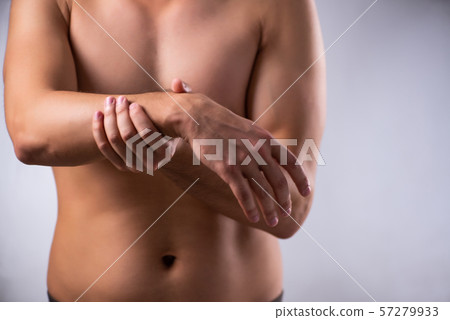 Young man suffering from upper limb pain 57279933