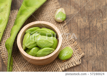 Sato seeds, Bitter bean in the Wooden bowl, Sack, Old grunge dark textured wooden background Sato seeds, Bitter bean in the Wooden bowl, Sack, Old grunge dark textured wooden background 57280024