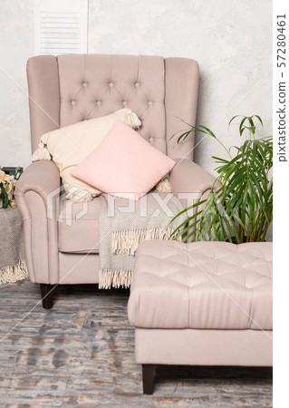 Stylish beige armchair with pink pillows in a bright minimalist interior Stylish beige armchair with pink pillows in a bright minimalist interior 57280461