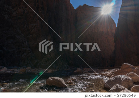 Todra Gorges, Morocco, Africa. Amazing high Rock cliffs and fresh stream river below Todra Gorges, Morocco, Africa. Amazing high Rock cliffs and fresh stream river below 57280549