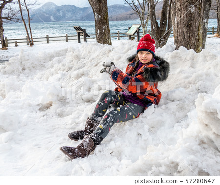 Young girl having fun in snow 57280647