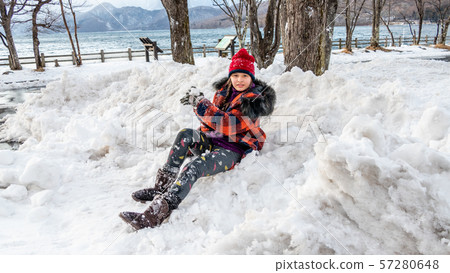 Young girl having fun in snow Young girl having fun in snow 57280648