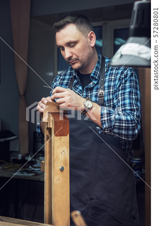 Concept of handmade craft production of leather goods. Concept of handmade craft production of leather goods. 57280801