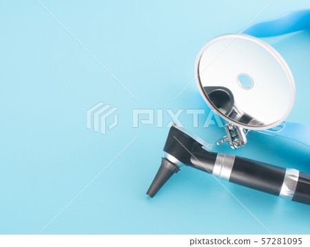 Otoscope with reflector mirror on blue background Otoscope with reflector mirror on blue background 57281095