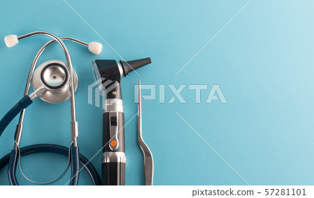 Otoscope with stethoscope on blue background. 57281101