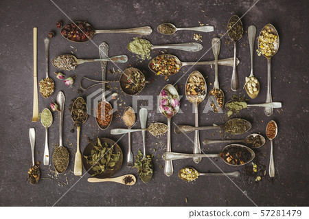 Assortment of dry tea in vintage spoons Assortment of dry tea in vintage spoons 57281479