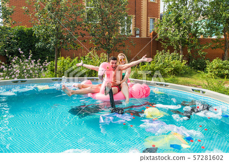 Problem of trash, plastic recycling, pollution and environmental concept - silly man and woman swim Problem of trash, plastic recycling, pollution and environmental concept - silly man and woman swim 57281602